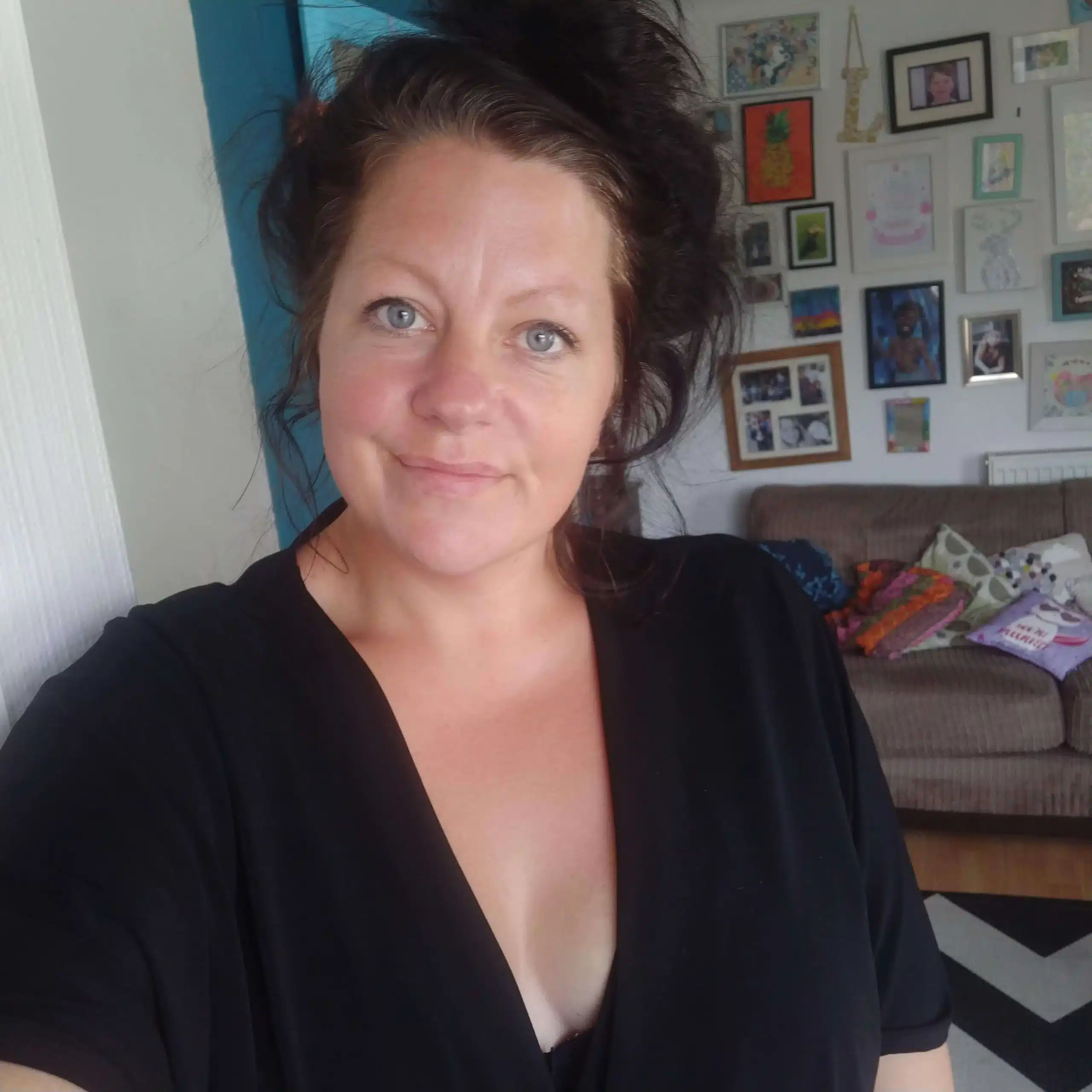 A profile picture of Lou Blakey, she is smiling and looking up to the left corner whilst holding a sample of her star wrapping paper