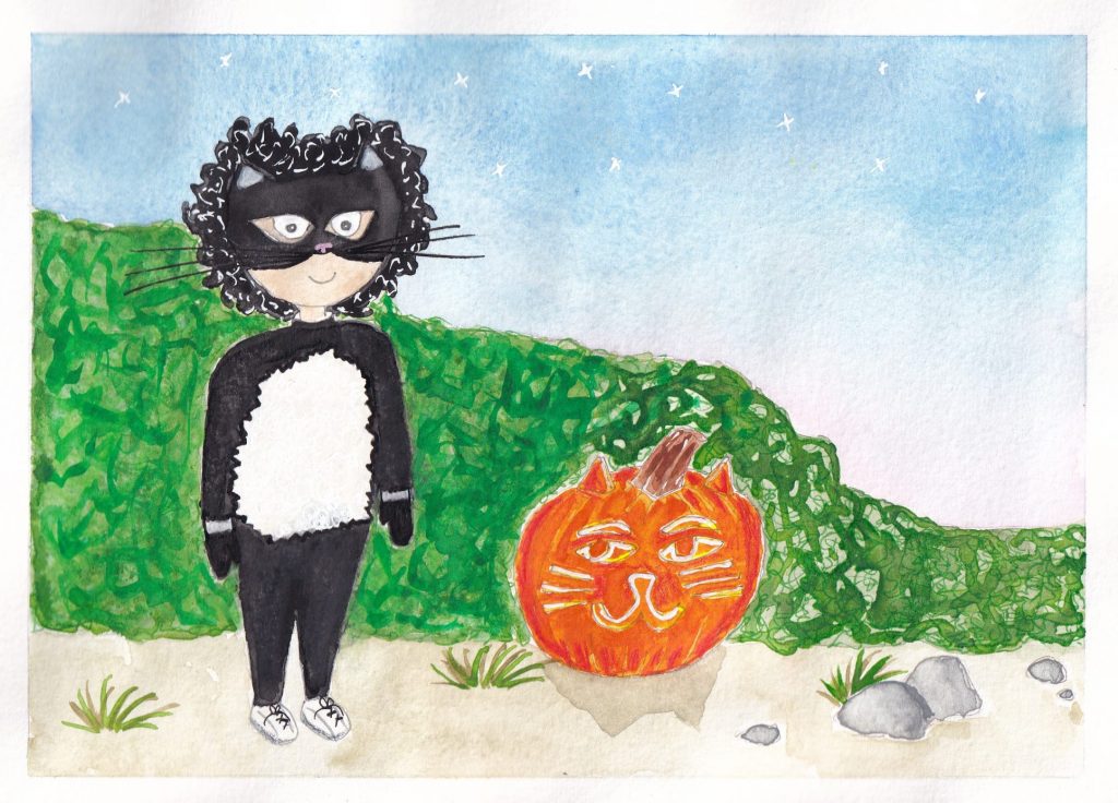 Bo has found a witches cat costume and is now wearing it very proudly. Bo has a cat mask and a black witch costume with a white tummy, Bo stands next to a lit pumpkin that has a cat face carved into it.