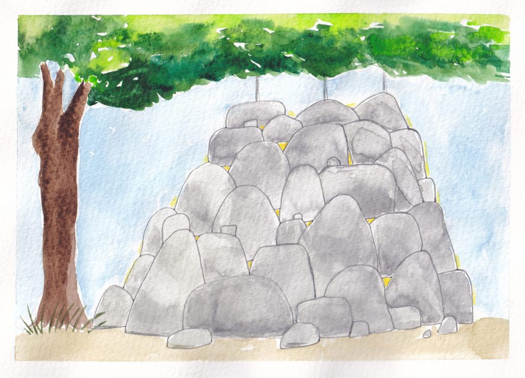 The rocks has turned into a massive pile of rocks, so high they are as high as the lowest branch on a nearby tree, it also appears that there is something hanging from the other side of the tree but the rocks are obscuring the scene.